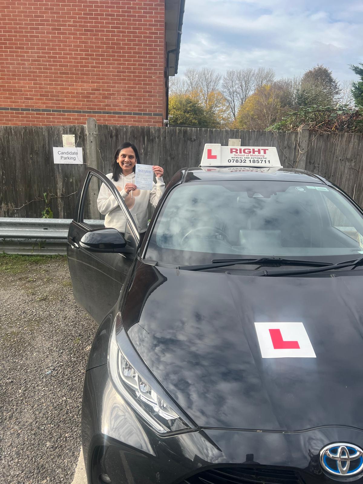 Celebrating student holding driving test pass certificate