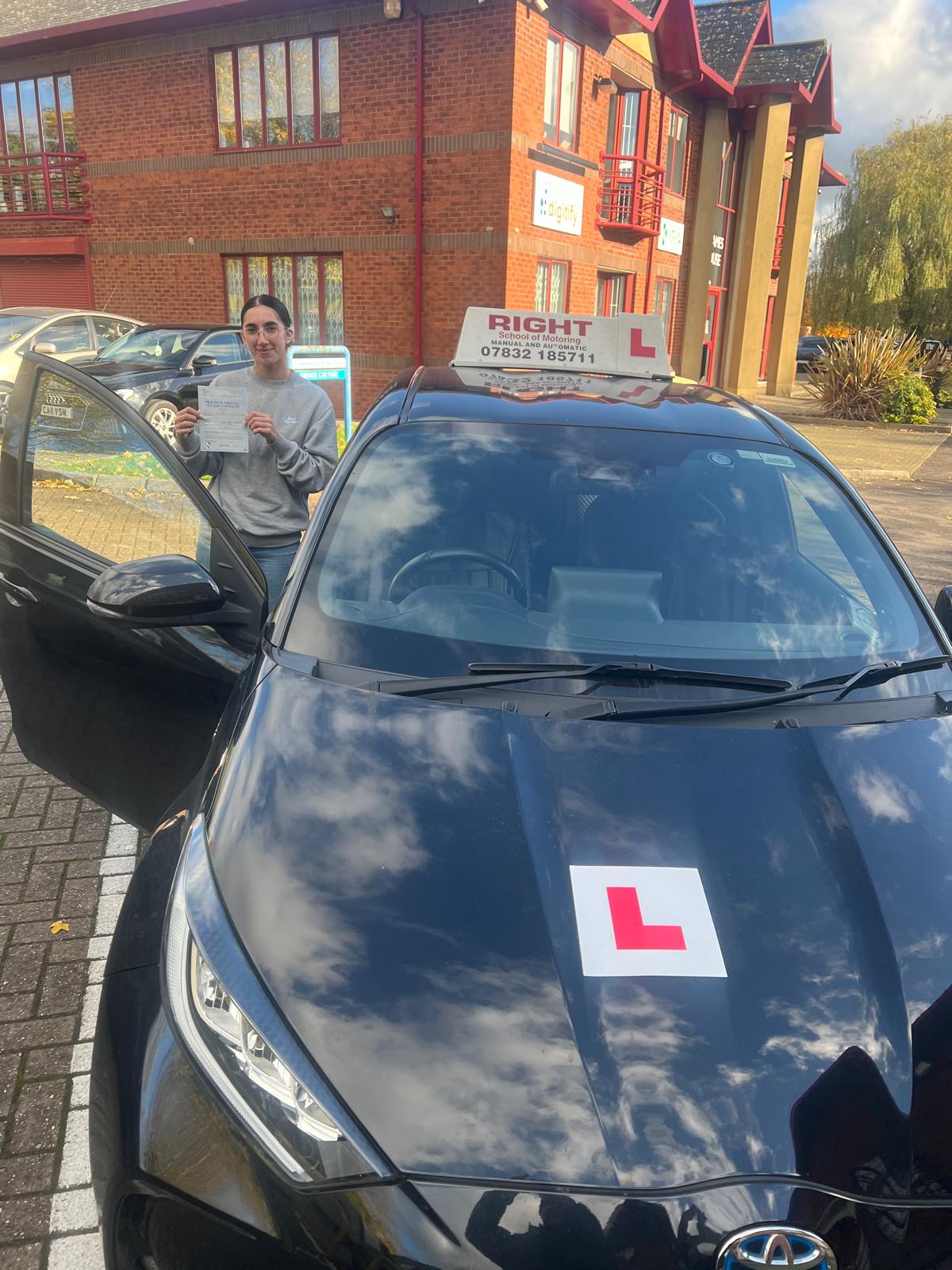 Student celebrating driving test pass with certificate